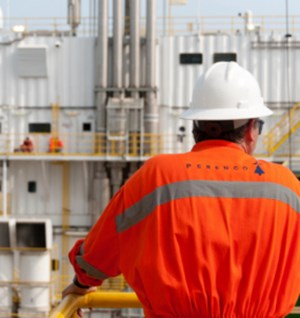 Perenco worker with hard hat and orange suit