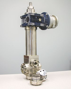 Fig. 2. A GEN 2 manual spring regulator, with attached air motor, plus tungsten carbide seal plate (front left) and tungsten carbide flow port (front right), after each has undergone 10,000 endurance testing cycles. The air motor, itself, was tested 1,000 cycles.