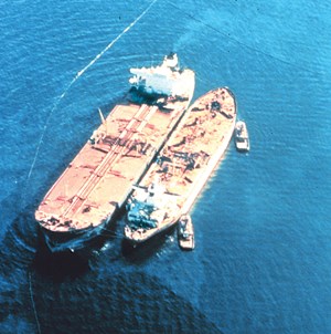 Fig. 2. The Exxon Valdez, aground on Bligh Reef being lightered to reduce oil spillage and lighten ship to get off reef. Image: NOAA
