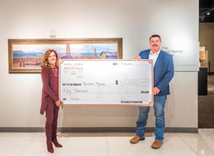Jeff Tranum, sales manager, ValTek, presents a $50,000 donation to Kathy Shannon, executive director, Permian Basin Petroleum Museum.
