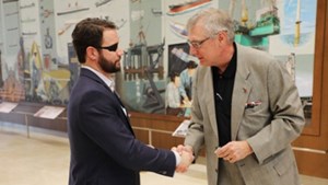 Dan Crenshaw and ABS President shake hands at ABS global headquarters.