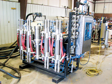 The advanced mechanical separation unit used in the test lab, showing four of eight filter cylinders and one of two hydraulic backwash pumps.
